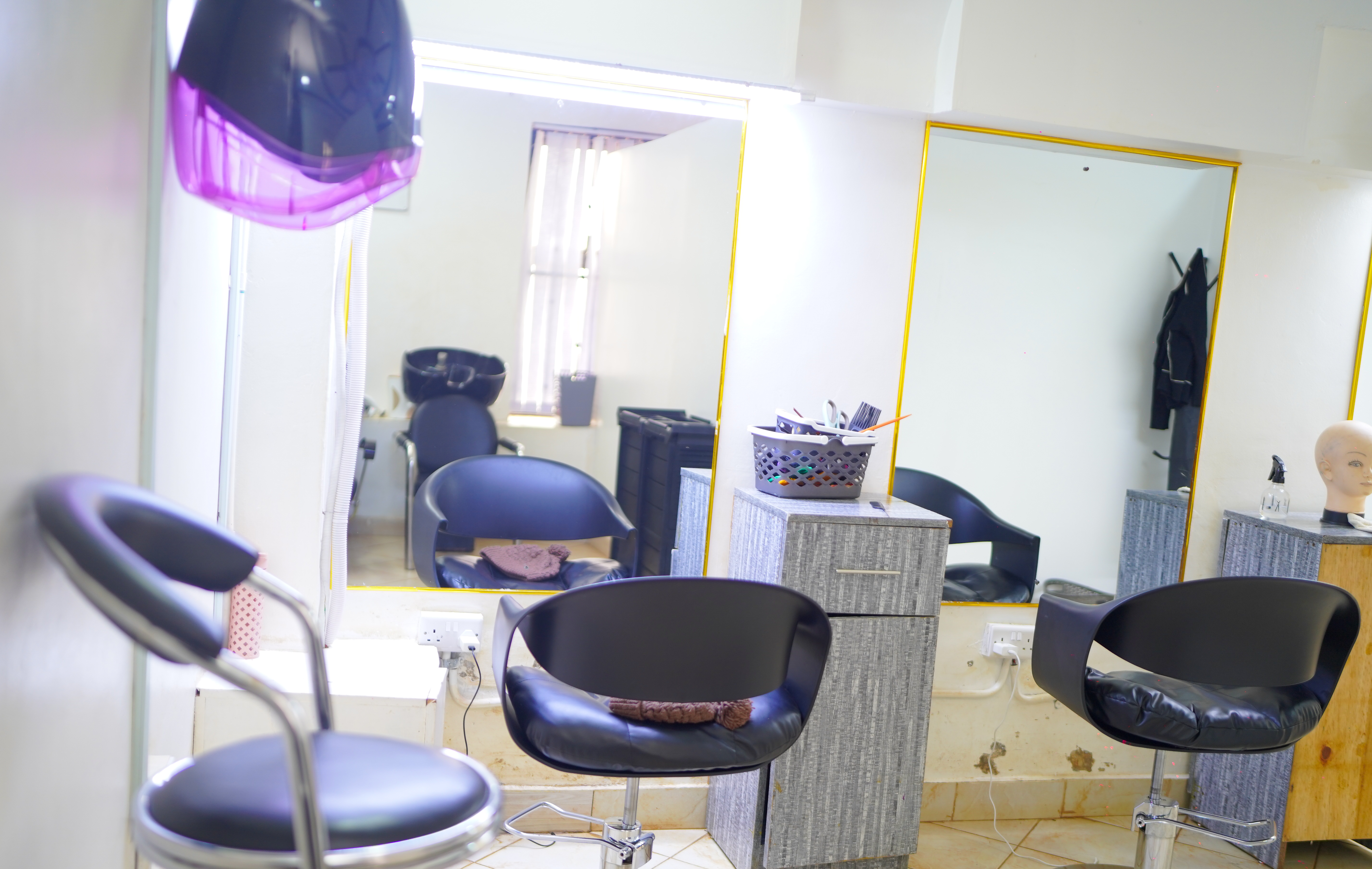 Salon interior — gold-framed mirrors and styling chairs