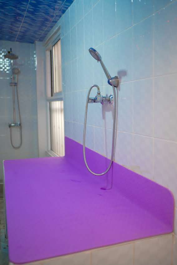 Moroccan Bath interior — purple treatment slab and chrome shower fittings