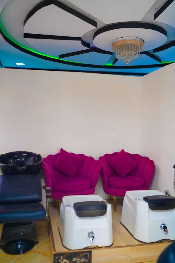 Nail Studio — fuchsia pedicure chairs and chandelier
