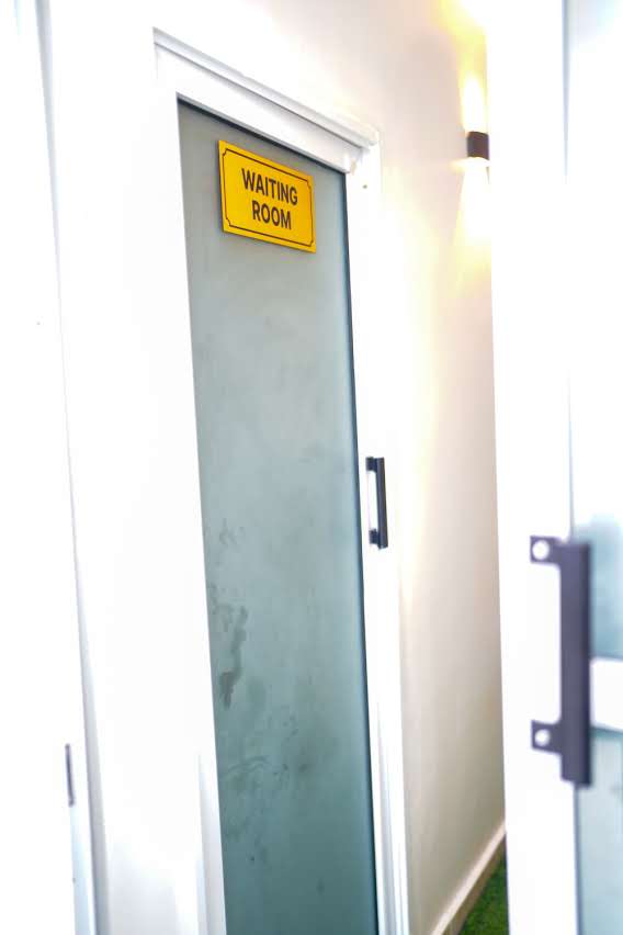 Waiting Room frosted glass door with warm wall lighting